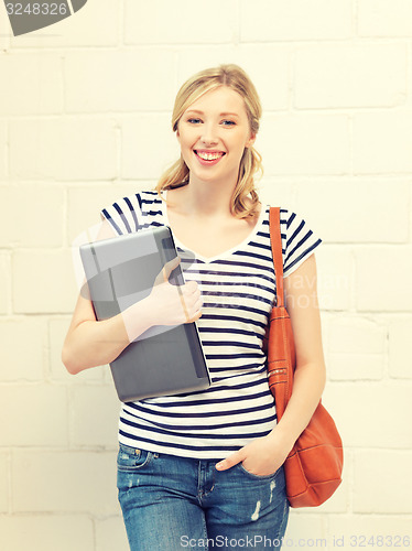 Image of happy and smiling teenage girl with laptop