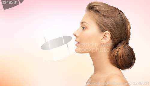 Image of beautiful young woman face over blue background