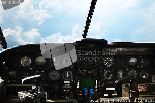 Image of dashboard in airplane cockpit and view of sky