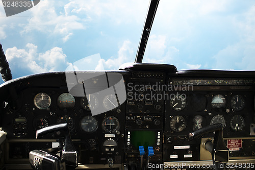 Image of dashboard in airplane cockpit and view of sky