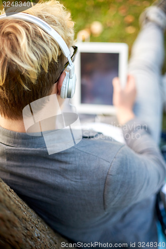 Image of close up of teenager in headphones with tablet pc