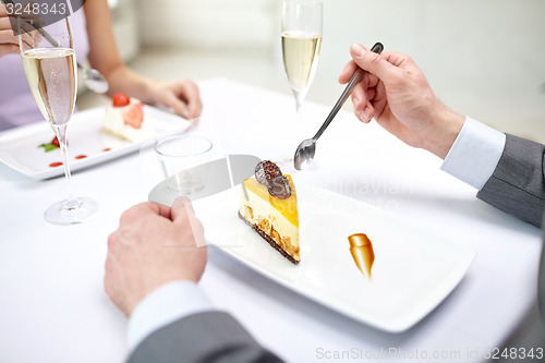 Image of close up of couple eating dessert at restaurant