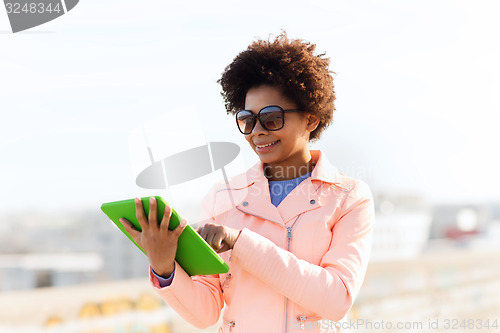 Image of happy young woman or teenage girl with tablet pc