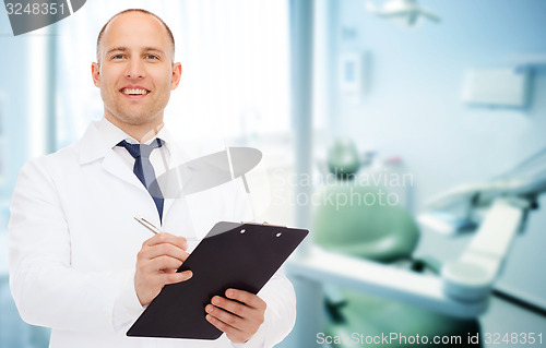 Image of smiling male doctor with clipboard