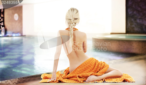 Image of beautiful young woman with orange towel