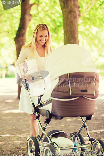 Image of happy mother with stroller in park