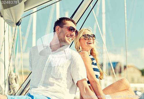 Image of smiling couple sitting on yacht deck