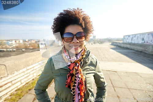 Image of happy african american woman in shades on street