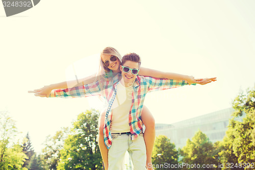 Image of smiling couple having fun in park