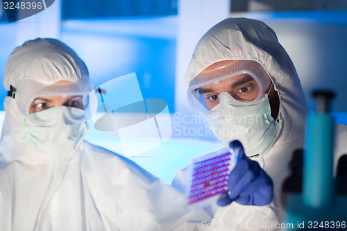 Image of close up of scientists making test in chemical lab