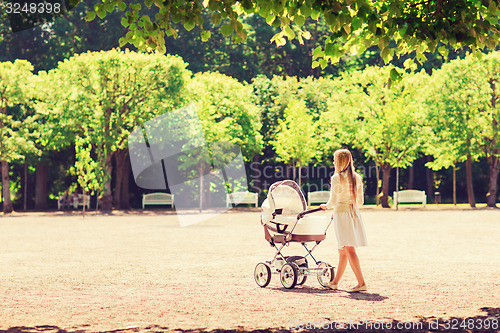 Image of happy mother with stroller in park