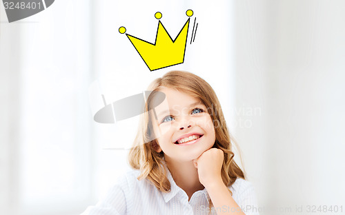 Image of smiling little school girl with crown
