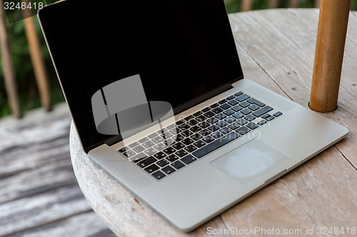 Image of close up of laptop computer on table at hotel