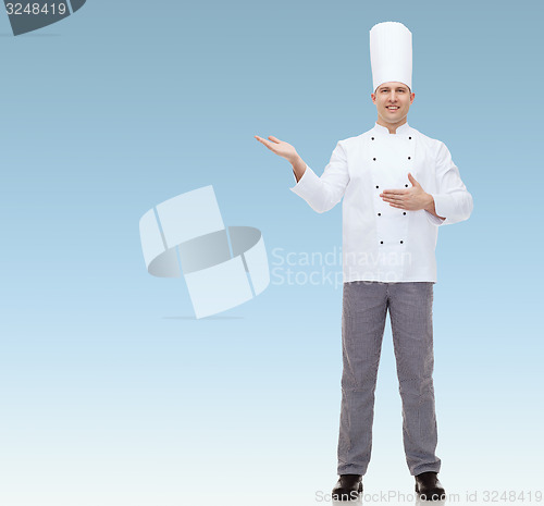 Image of happy male chef cook inviting