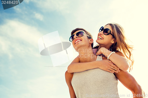 Image of smiling couple having fun over sky background