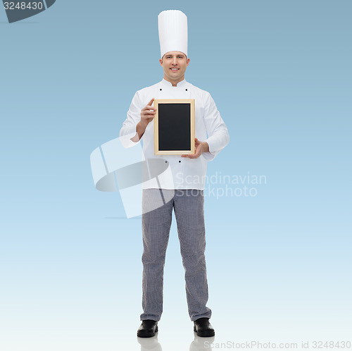 Image of happy male chef cook holding blank menu board