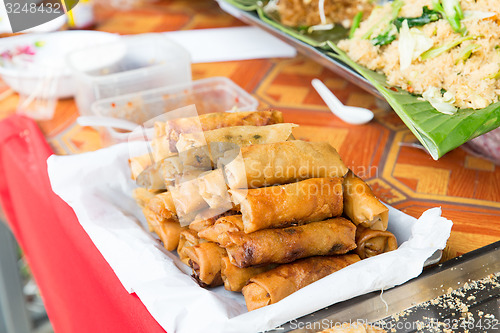 Image of spring rolls and snacks at street market