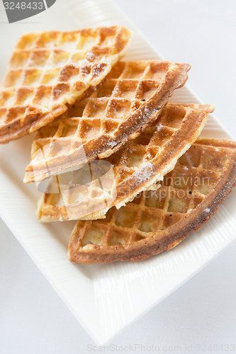 Image of close up of waffles on plate at breakfast table