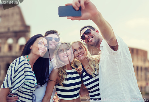 Image of friends taking selfie with smartphone