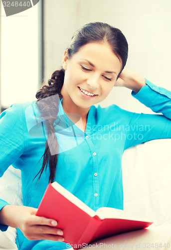 Image of happy and smiling woman with book