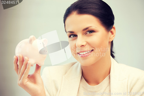 Image of lovely woman with piggy bank