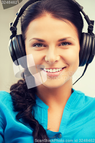 Image of happy teenage girl in big headphones