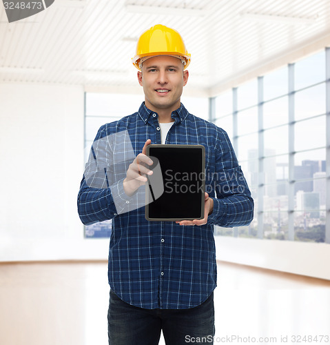 Image of smiling male builder in helmet with tablet pc