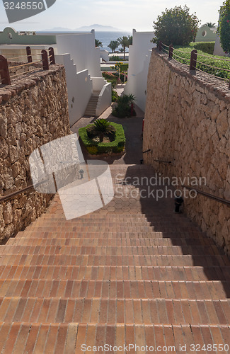 Image of Stairs with steps leading to the sea at luxury hotel