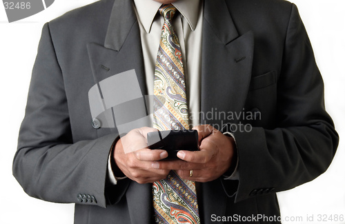 Image of Business man holding blackberry