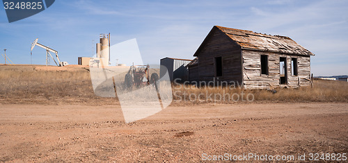 Image of Fracking Operation Built on Previous Farmland Abandoned Cabin