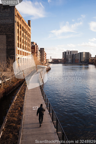 Image of Man Walks Boardwalk Downtown Milwaukee Wisconsin River Walk 