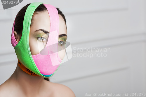 Image of closeup portrait of beautiful young woman with creative makeup 