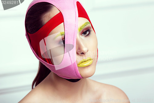 Image of closeup portrait of beautiful young woman with creative makeup 