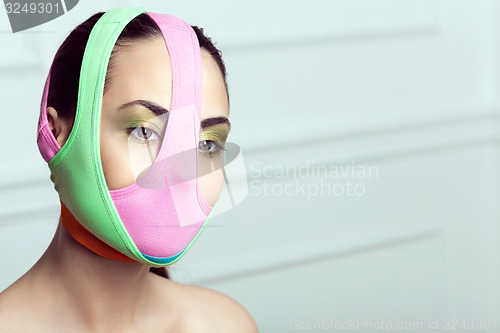 Image of closeup portrait of beautiful young woman with creative makeup 