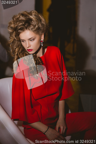 Image of beautiful blonde woman with red lips and curly hairs