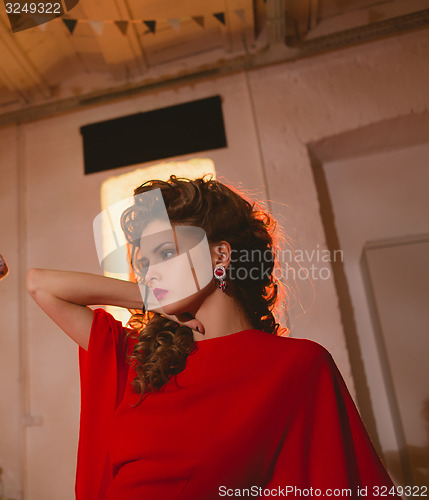 Image of beautiful blonde woman with red lips and curly hairs