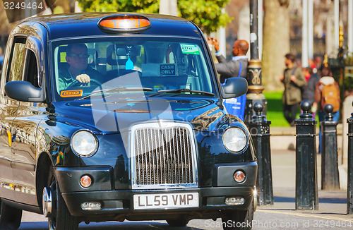 Image of Famous black cab an a street in London