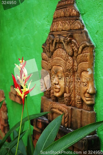 Image of Thai tropical flower with traditional Buddhist image.