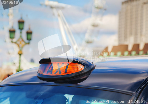 Image of Famous black cab an a street in London