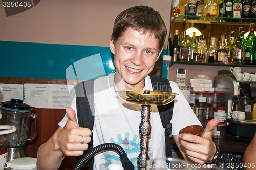 Image of The young man behind the bar