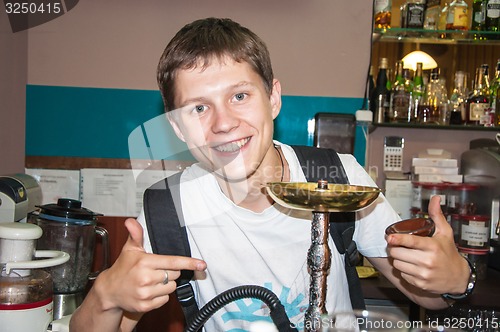 Image of The young man behind the bar