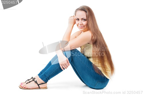 Image of Young female sitting on the floor