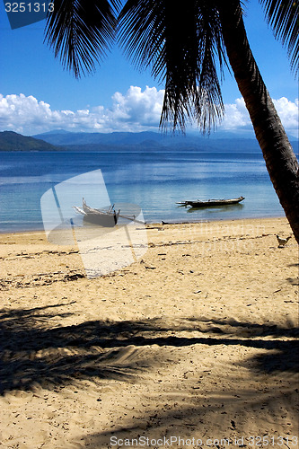 Image of  madagascar nosy be rock  palm branch boat and coastline