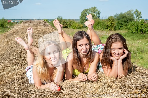 Image of Young beautiful women on hay