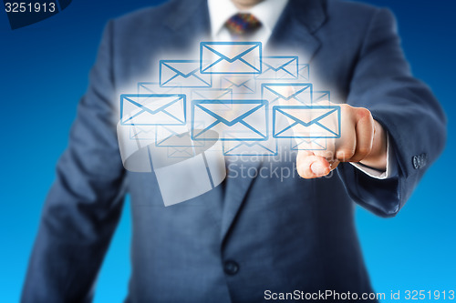 Image of Business Man Touching A Cloud Of Many Email Icons