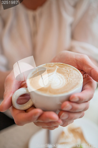 Image of Cup of delicious coffee with a heart