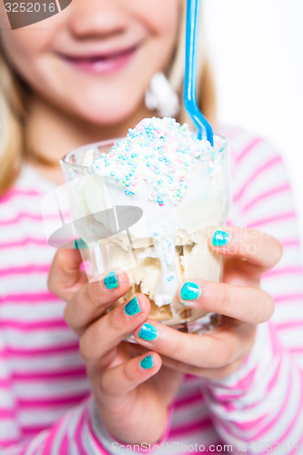 Image of Girl holding ice cream dessert