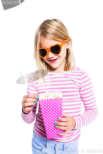 Image of Girl eating pop corn and smiling