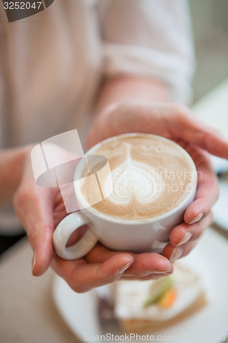 Image of Cup of delicious coffee with a heart