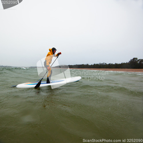 Image of Woman on a stand up paddle board